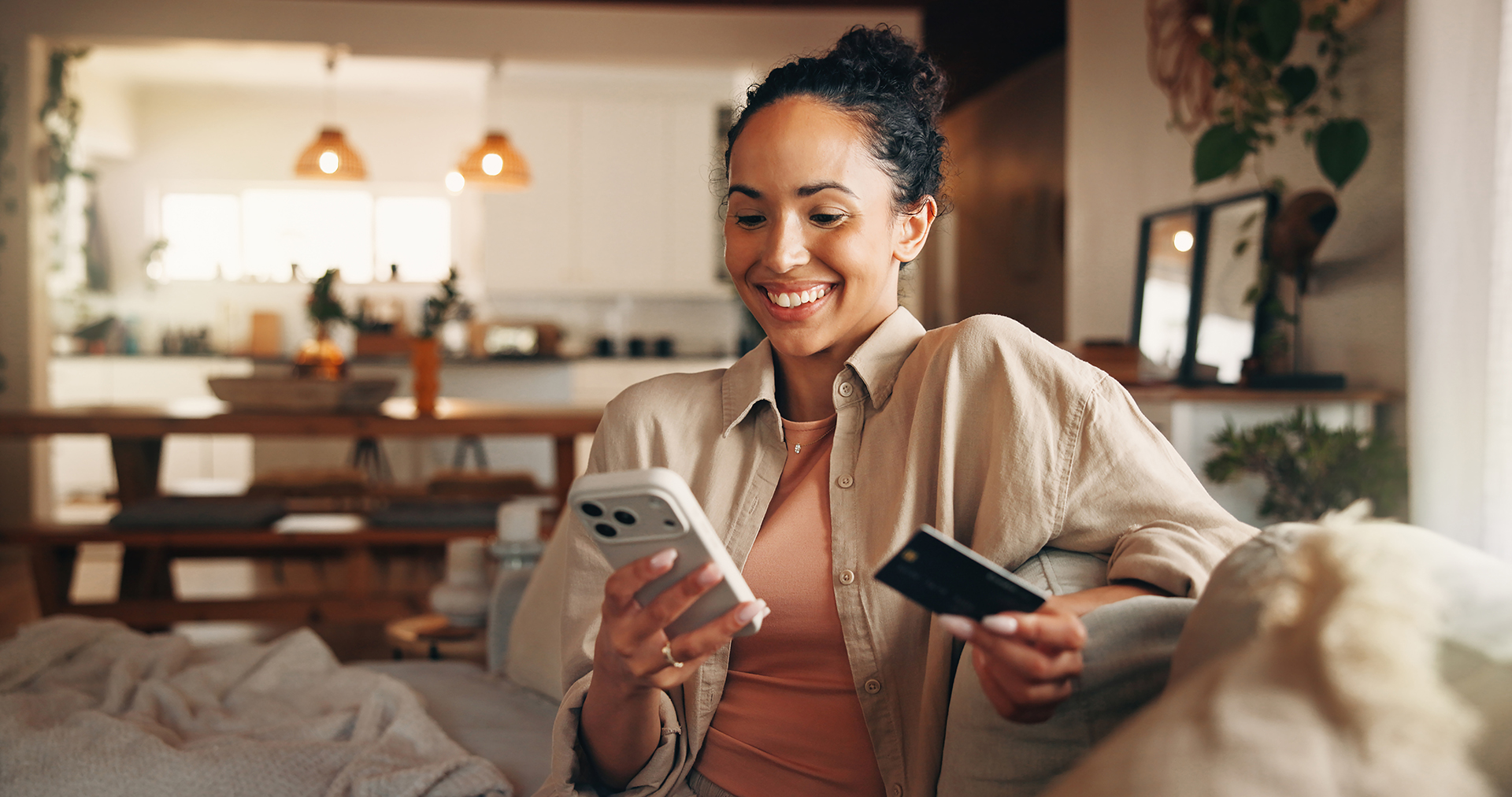 Phone, payment and happy woman in home with credit card